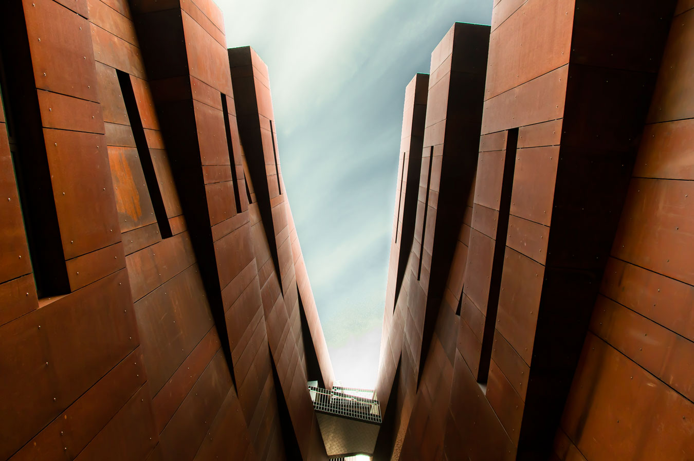Looking up through the crevice between office towers Looking up through the crevice between office towers