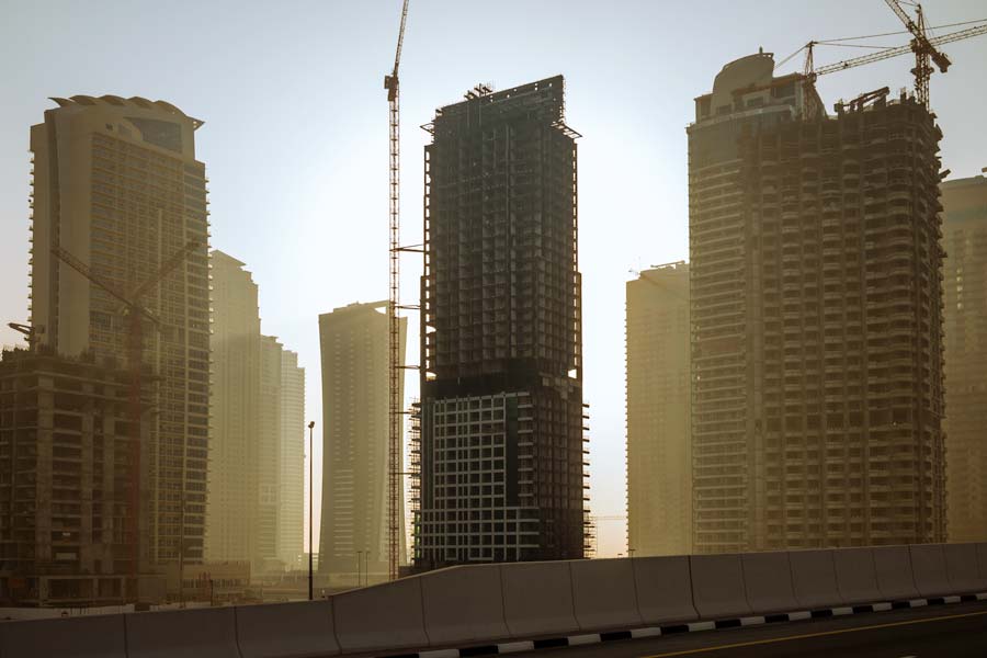 The morning sun takes a peek around the highrises on Sheikh Zayed Rd (E11 Highway)