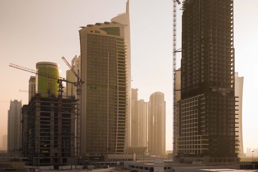 The morning sun takes a peek around the highrises on Sheikh Zayed Rd (E11 Highway)
