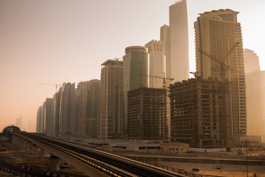 The morning sun takes a peek around the highrises on Sheikh Zayed Rd (E11 Highway)