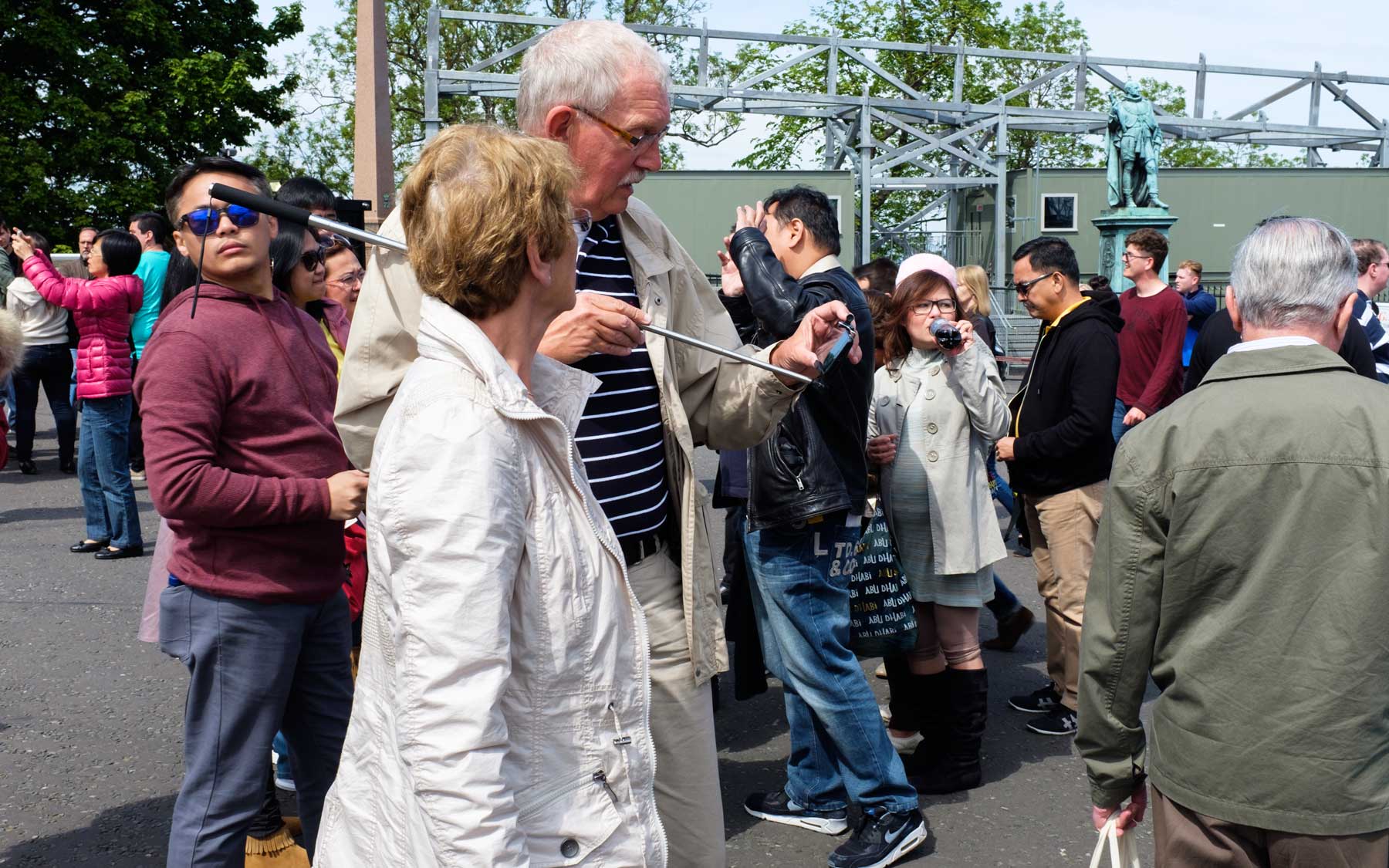 A selfie stick is prepared in front of Edinburgh Castle