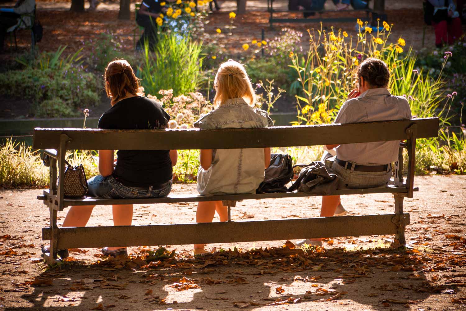 Local women take a quiet moment just off the main central pathway.