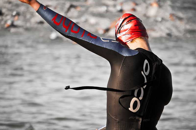 A female competitor warms up before race start as the men's race begins